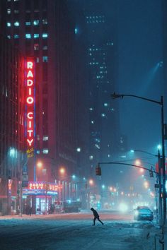 a person crossing the street at night in front of a radio city sign and buildings