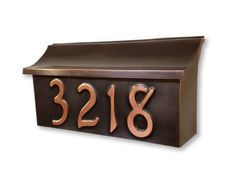 a metal mailbox with the number 2138 on it's front and side