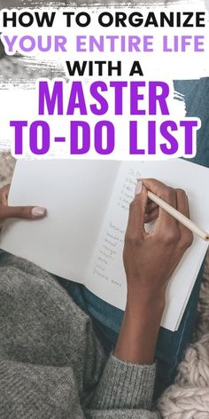 a person writing on a notebook with the title how to organize your entire life with a master to - do list