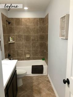 the bathroom is clean and ready to be used as a bathtub, shower head, and toilet