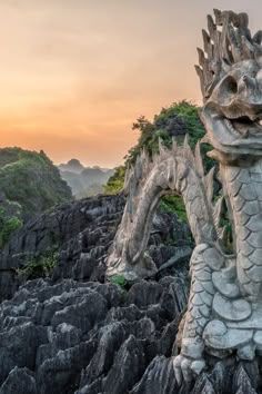 a dragon statue on top of some rocks