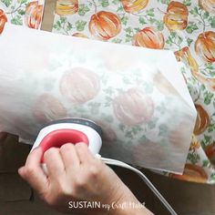 a person is using an electric device to make wrapping paper