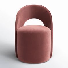 a pink chair sitting on top of a white floor