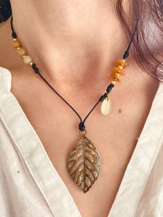 ️️🍁 ✨ Autumn leaf and yellow Aventurine necklace ✨ Natural stones and golden beads on black waxed cord, aged gold charm and clasp, glitter and gold leaf details🌙🕯️📿🪞 ✨ Yellow aventurine brings calm and balances emotions, it soothes and strengthens self-esteem by giving strength and courage. It also boosts creativity and positivity 💛 ✨ Adjustable cord length between 40 and 46cm ✨ Pendant 5 x 2.5cm #necklace #jewel #handmade #pearls #magic #craftswoman #gems #naturalstones #jewelry #crafts # Yellow Aventurine, Aventurine Necklace, Golden Beads, Boost Creativity, Autumn Leaf, Necklace Gemstone, Gold Charm, Pearl Beads, Gold Leaf