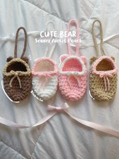 four crocheted baby shoes with bows on them