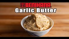 a bowl filled with garlic butter sitting on top of a wooden table next to the words behmaa garlic butter