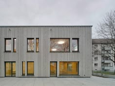 the building has four windows and is made out of wood, with glass doors on each side