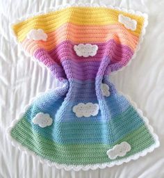 there is a crocheted dress with clouds on it