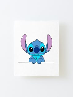 a cute little blue stitcher sitting on top of a white square canvas mounted to a wall