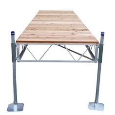 a wooden table sitting on top of two metal legs with one leg raised to the side