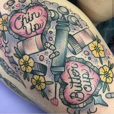 a woman's thigh with tattoos on it and the words love is in the background