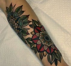 a woman's arm with a flower tattoo on it