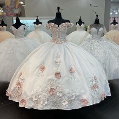 wedding gowns are displayed on mannequins in a store