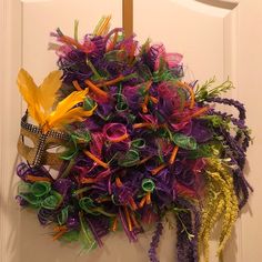 a colorful wreath hanging on the front door