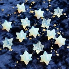 small white stars on a blue background with gold flakes and sparkles around them