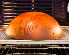 an uncooked loaf of bread sitting on top of an oven rack in the oven