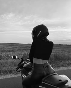 black and white photograph of a person on a motorcycle