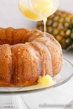 a pineapple bunt cake is being drizzled with icing on a plate