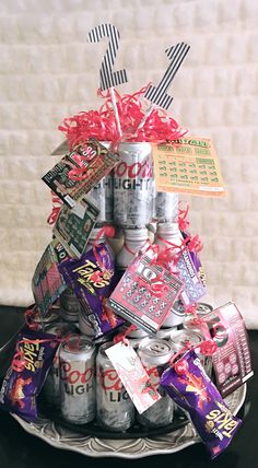 a christmas tree made out of cans with candy and candies in them on a plate