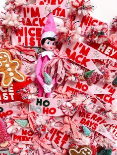 a christmas tree made out of pink and red paper with gingerbreads on it