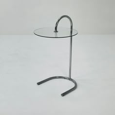 a round glass table with metal legs