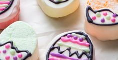 several decorated cookies sitting on top of a table