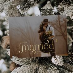 a christmas ornament hanging on a tree with the words married printed on it