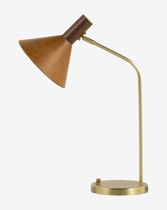 a desk lamp with a wooden shade on the top and a metal base, against a white background