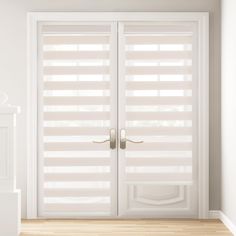 an open white door with blinds on the outside and wooden floors in front of it