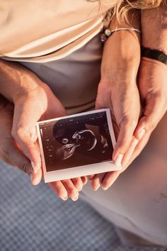 a woman holding an old photo in her hands