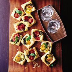 small appetizers are arranged on a cutting board