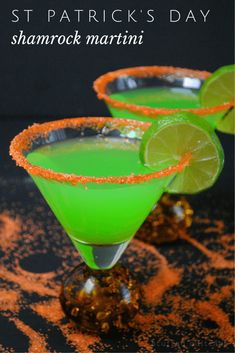 two glasses filled with green liquid and garnished with orange sprinkles