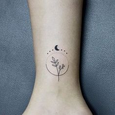 a small tattoo on the ankle of a woman's foot with a flower and moon