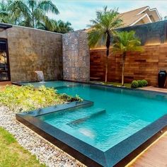 an outdoor swimming pool in the middle of a yard