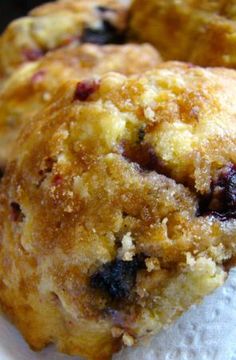 three blueberry muffins sitting on top of a paper towel