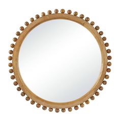 a round wooden mirror with beaded trim