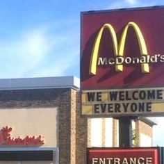 a mcdonald's restaurant sign in front of the entrance