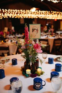 a table with flowers and candles on it