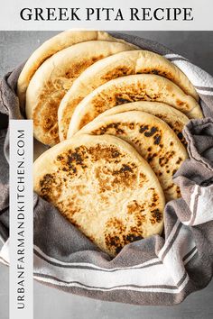 four pita breads sitting on top of a white and gray cloth with the title greek pita recipe