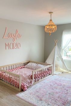 a baby's room is decorated in pink and gray colors with a teepee tent