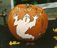 a painted pumpkin with a ghost on it