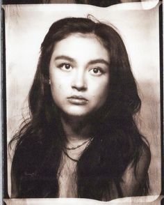 an old photo of a woman with long hair