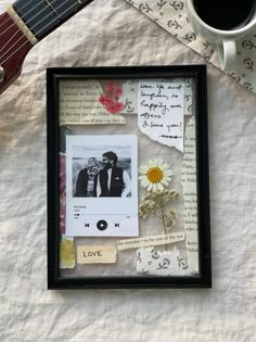 an old photo frame with music notes, flowers and a guitar