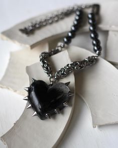 The necklace is made of steel and metal fittings with blackening.  The necklace is short, with a heart pendant relevant for 2024. the spikes are made of steel, the heart is epoxy resin. the author's technique is completely handmade. a glossy-coated heart. The necklace is 19,5 inches long. You can fix the lock in a shorter version. Lock:  1/2 inch carabiner Do not expose to prolonged contact with water, leave in the sun. avoid contact with creams and perfumes. observing these rules, the decoration will delight you for a long time Black Heart Necklace, Spike Necklace, Chocker Necklace, Real Jewelry, Keep Jewelry, Black Heart, Steel Jewelry, Jewelry Inspo, Cool Clothes