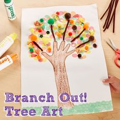 a child's hand is drawing a tree out of paper with the words branch out free art on it