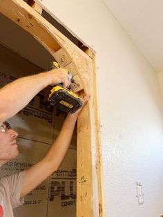 a man is working on the wall in his house