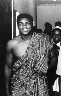 an old photo of a man wearing a towel around his body and smiling at the camera