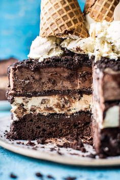 a chocolate cake with ice cream on top and two waffles sticking out of it