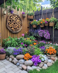 a garden with lots of different flowers and plants in the center, along with a wooden fence