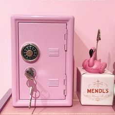 there is a pink locker and keys on the shelf